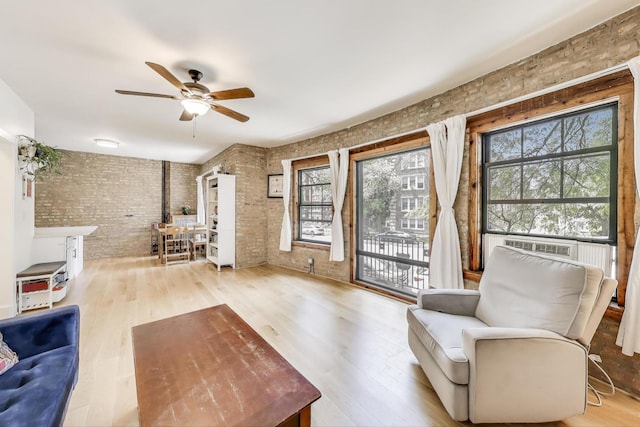 7021 N Sheridan Rd Unit 1, Chicago, IL 60626 - living area featuring brick wall, a ceiling fan, and wood finished floors