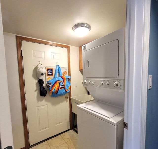 11009 Stony Creek Dr Unit 1C, Palos Hills, IL 60465 - washroom featuring stacked washer / drying machine, light floors, and cabinet space
