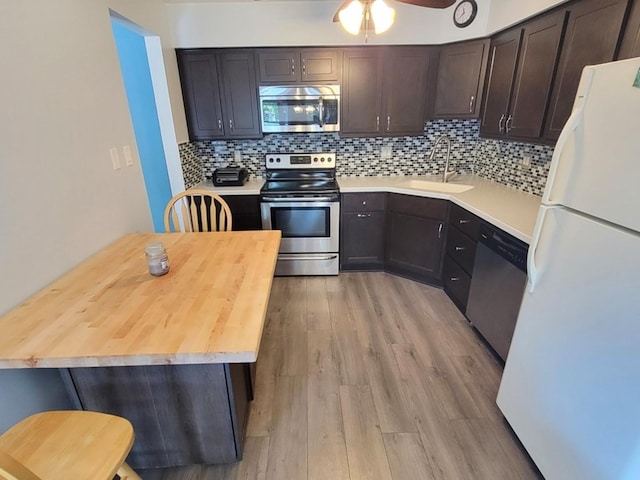 11009 Stony Creek Dr Unit 1C, Palos Hills, IL 60465 - kitchen featuring stainless steel appliances, light wood-style flooring, backsplash, dark brown cabinetry, and ceiling fan