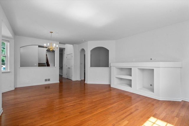 270 Birch Ln, Saint Charles, IL 60175 - unfurnished living room with a chandelier, wood finished floors, and arched walkways