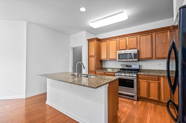 270 Birch Ln, Saint Charles, IL 60175 - kitchen featuring stainless steel appliances, brown cabinets, light wood-style floors, a center island with sink, and recessed lighting