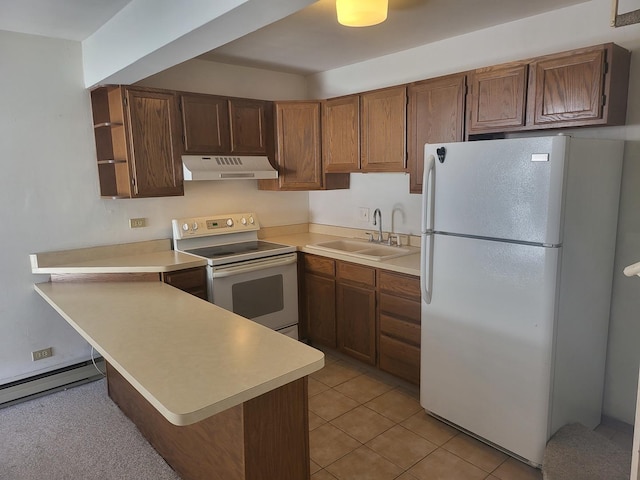 32 Montego Colony Unit 7, Fox Lake, IL 60020 - kitchen featuring white appliances, under cabinet range hood, a peninsula, light countertops, and baseboard heating