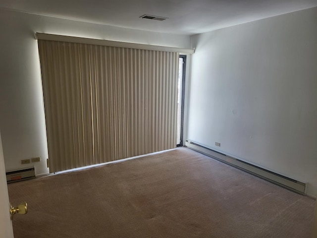 32 Montego Colony Unit 7, Fox Lake, IL 60020 - spare room featuring a baseboard radiator, baseboard heating, and carpet