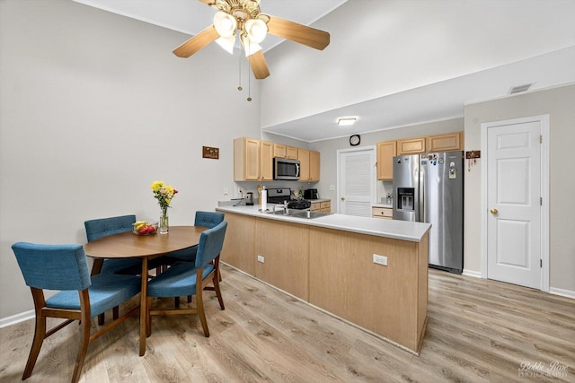 620 S Annandale Dr, Lake In The Hills, IL 60156 - kitchen featuring appliances with stainless steel finishes, a towering ceiling, a peninsula, light wood-type flooring, and light brown cabinets