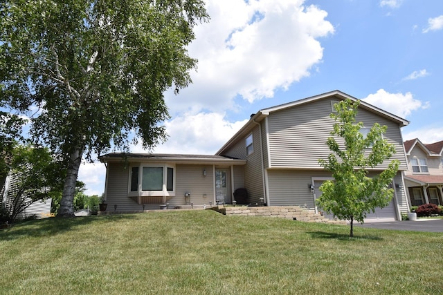 963 E Castlewood Ln, Bartlett, IL 60103 - view of front of house featuring a front lawn, asphalt driveway, and a garage
