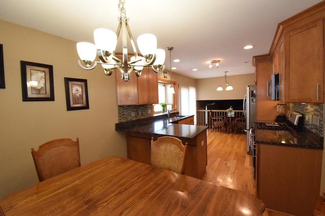 963 E Castlewood Ln, Bartlett, IL 60103 - kitchen with a chandelier, appliances with stainless steel finishes, backsplash, brown cabinets, and recessed lighting