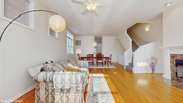 4606 S Woodlawn Ave, Chicago, IL 60653 - living area featuring stairway, wood finished floors, a high end fireplace, and ceiling fan