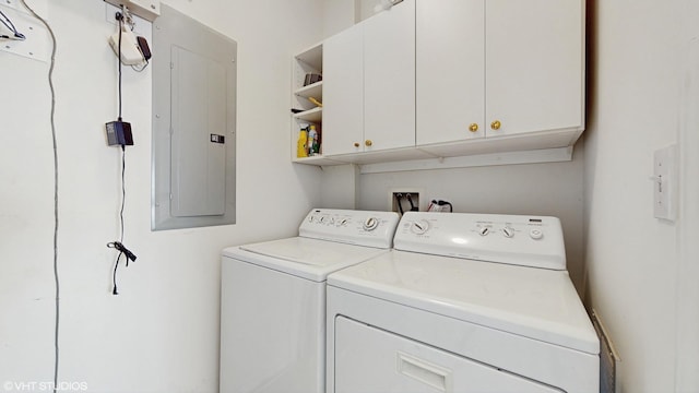 4606 S Woodlawn Ave, Chicago, IL 60653 - laundry area featuring washing machine and dryer, cabinet space, and electric panel