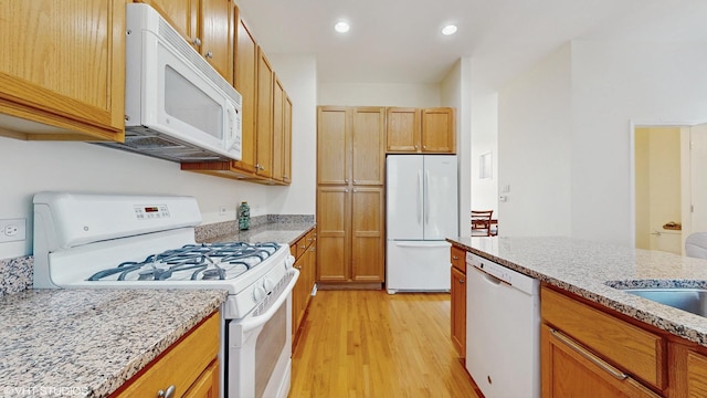 4606 S Woodlawn Ave, Chicago, IL 60653 - kitchen featuring white appliances, light wood-type flooring, recessed lighting, and light stone countertops
