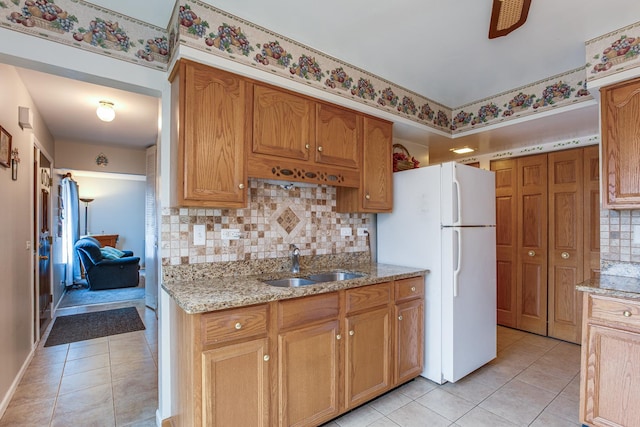 7315 Winthrop Way Unit 6, Downers Grove, IL 60516 - kitchen with freestanding refrigerator, light tile patterned flooring, decorative backsplash, and light stone countertops