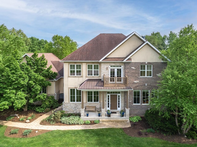 660 Birch Hollow Dr, Antioch, IL 60002 - back of property featuring a balcony, a standing seam roof, a yard, a patio, and roof with shingles