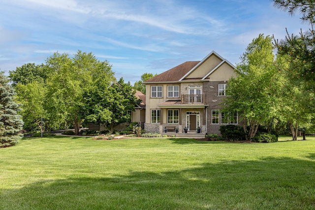660 Birch Hollow Dr, Antioch, IL 60002 - back of property featuring a balcony, a yard, stucco siding, and stone siding