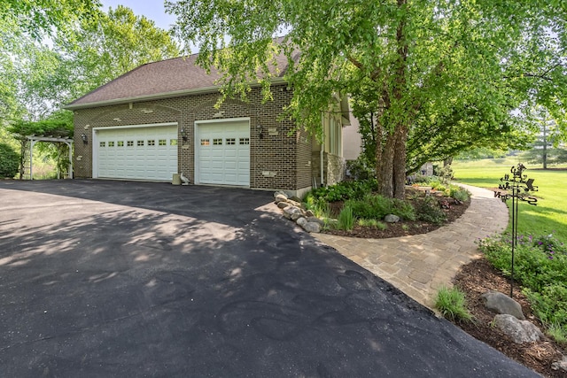 660 Birch Hollow Dr, Antioch, IL 60002 - view of front of house with asphalt driveway, brick siding, an attached garage, and a shingled roof