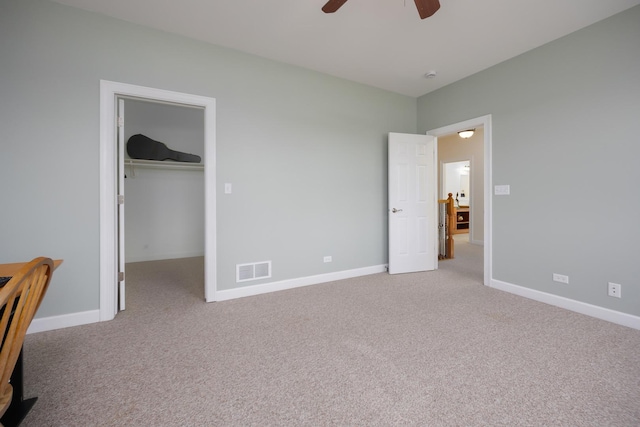 660 Birch Hollow Dr, Antioch, IL 60002 - unfurnished bedroom featuring light carpet, a walk in closet, and a ceiling fan