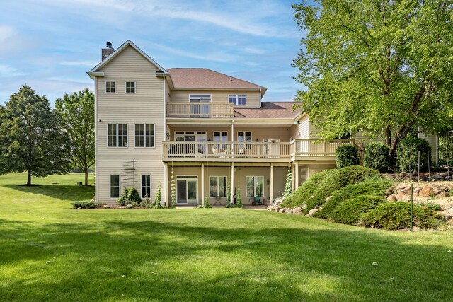 660 Birch Hollow Dr, Antioch, IL 60002 - back of property with a chimney, a lawn, a wooden deck, a balcony, and roof with shingles