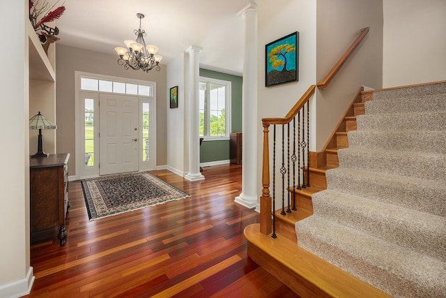 660 Birch Hollow Dr, Antioch, IL 60002 - entrance foyer with wood finished floors, stairs, a chandelier, and decorative columns
