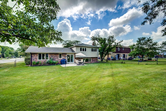 13520 Idlewild Dr, Orland Park, IL 60462 - rear view of house with a patio, a fenced backyard, brick siding, and a chimney