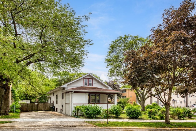 7530 Brown Ave, Forest Park, IL 60130 - view of front of house with covered porch, stucco siding, and concrete driveway