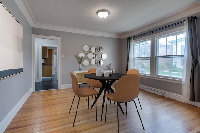 7530 Brown Ave, Forest Park, IL 60130 - dining room featuring light wood-style flooring, crown molding, and a baseboard heating unit