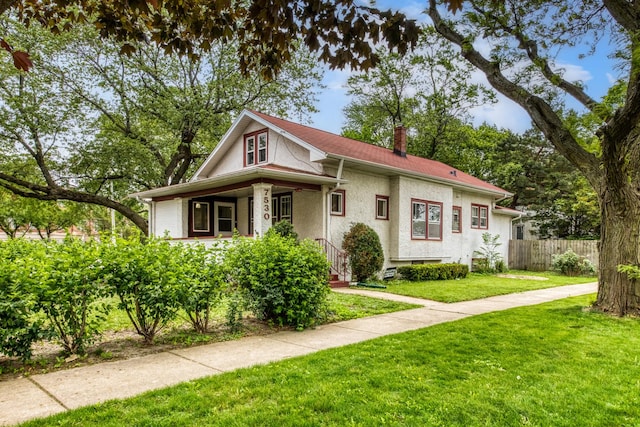 7530 Brown Ave, Forest Park, IL 60130 - bungalow with stucco siding, a chimney, and covered porch