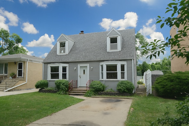 215 W Kimbell Ave, Elmhurst, IL 60126 - new england style home with a front lawn and roof with shingles