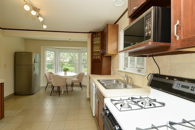 215 W Kimbell Ave, Elmhurst, IL 60126 - kitchen with stainless steel appliances, light countertops, tasteful backsplash, light tile patterned flooring, and brown cabinets
