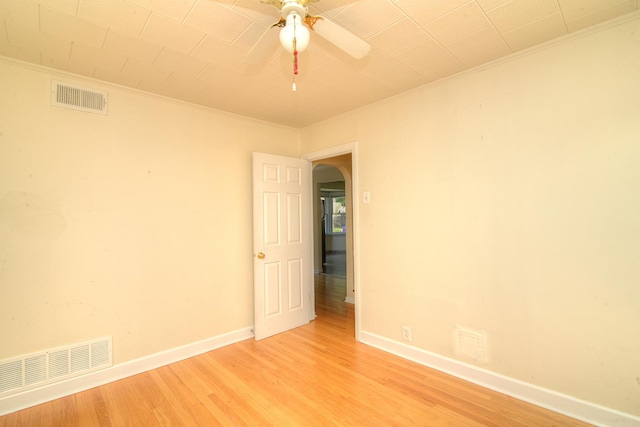 215 W Kimbell Ave, Elmhurst, IL 60126 - empty room featuring arched walkways, ornamental molding, ceiling fan, and light wood finished floors