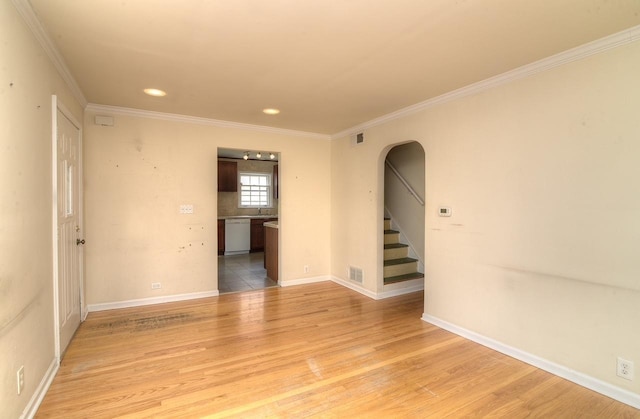 215 W Kimbell Ave, Elmhurst, IL 60126 - unfurnished room with arched walkways, light wood-style flooring, crown molding, stairway, and recessed lighting