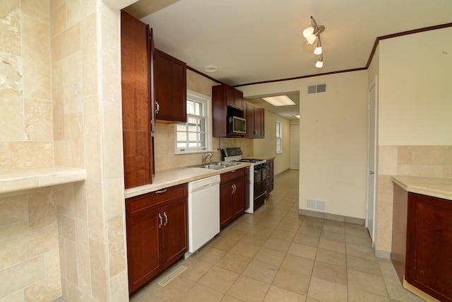 215 W Kimbell Ave, Elmhurst, IL 60126 - kitchen with white dishwasher, range with gas cooktop, light countertops, light tile patterned flooring, and crown molding