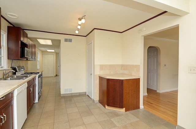 215 W Kimbell Ave, Elmhurst, IL 60126 - kitchen featuring white appliances, arched walkways, crown molding, light countertops, and light tile patterned flooring