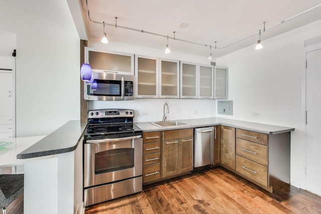 3600 N Lake Shore Dr Unit 2204, Chicago, IL 60613 - kitchen with appliances with stainless steel finishes, a peninsula, wood finished floors, glass insert cabinets, and brown cabinetry