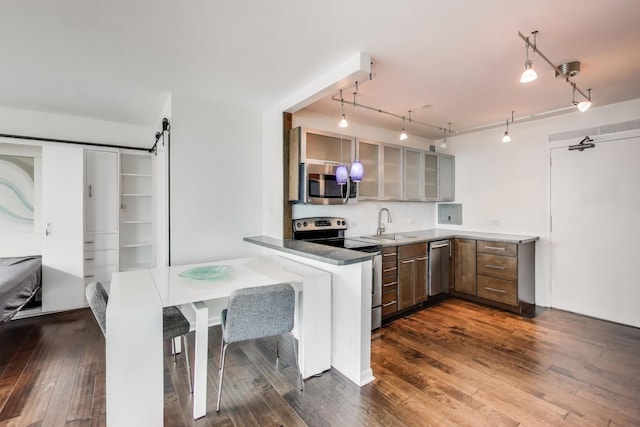 3600 N Lake Shore Dr Unit 2204, Chicago, IL 60613 - kitchen with stainless steel appliances, glass insert cabinets, dark wood finished floors, and track lighting
