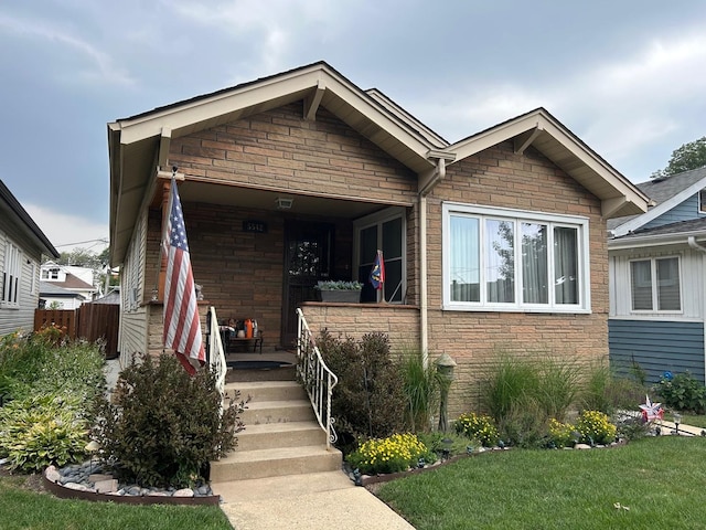 5542 W Grace St, Chicago, IL 60641 - view of front of home with stone siding and a porch