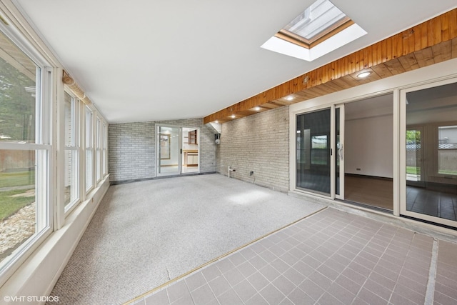 9061 Primrose Ln, Hickory Hills, IL 60457 - unfurnished sunroom featuring brick wall, a skylight, and lofted ceiling