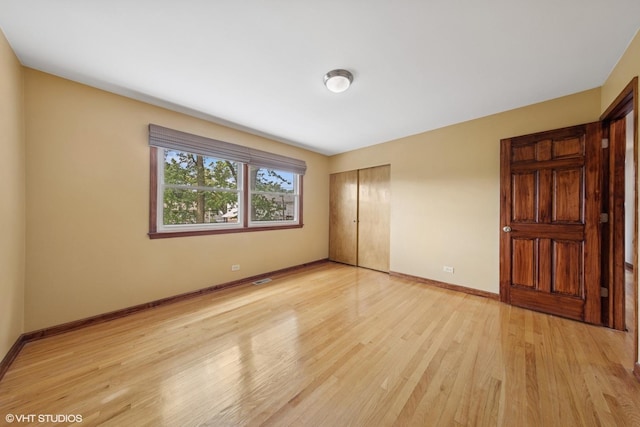 9061 Primrose Ln, Hickory Hills, IL 60457 - unfurnished bedroom with a closet and light wood-style floors