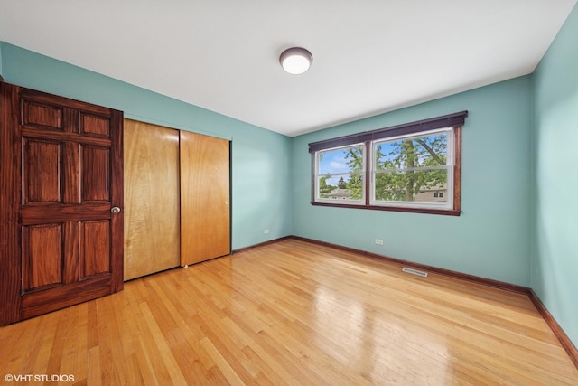 9061 Primrose Ln, Hickory Hills, IL 60457 - unfurnished bedroom featuring light wood-style floors and a closet
