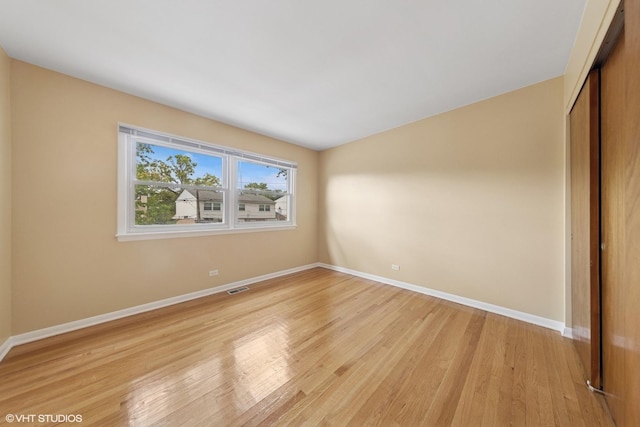 9061 Primrose Ln, Hickory Hills, IL 60457 - unfurnished bedroom with a closet and light wood-style flooring
