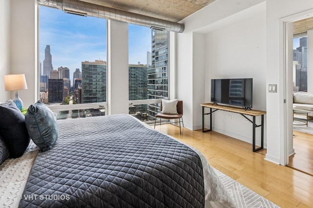 700 N Larrabee St Unit 1409, Chicago, IL 60654 - bedroom with wood finished floors, multiple windows, and floor to ceiling windows