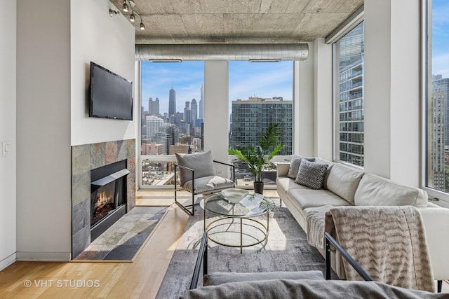 700 N Larrabee St Unit 1409, Chicago, IL 60654 - living area with wood finished floors, plenty of natural light, a tile fireplace, and rail lighting