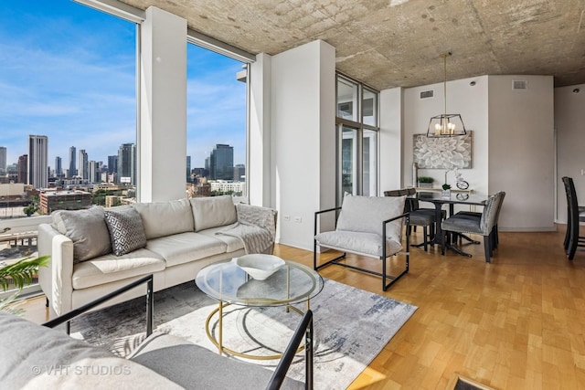 700 N Larrabee St Unit 1409, Chicago, IL 60654 - living room with a chandelier, a view of skyline, wood finished floors, and floor to ceiling windows