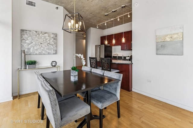700 N Larrabee St Unit 1409, Chicago, IL 60654 - dining area with light wood-style floors and a chandelier