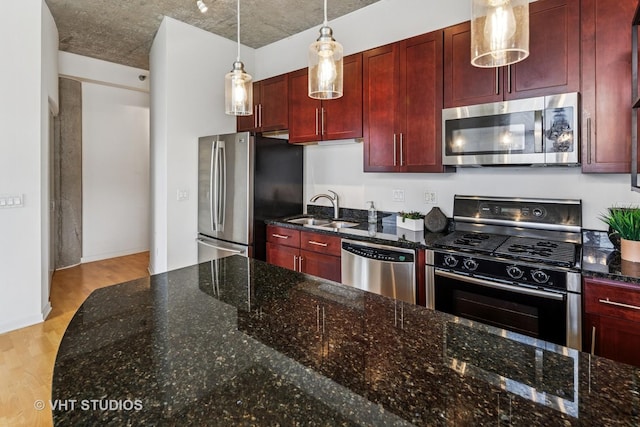 700 N Larrabee St Unit 1409, Chicago, IL 60654 - kitchen featuring appliances with stainless steel finishes, reddish brown cabinets, and light wood-type flooring