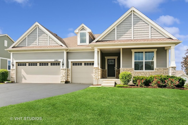 1140 River Birch Blvd, Crystal Lake, IL 60012 - craftsman house with driveway, a front yard, stone siding, and an attached garage