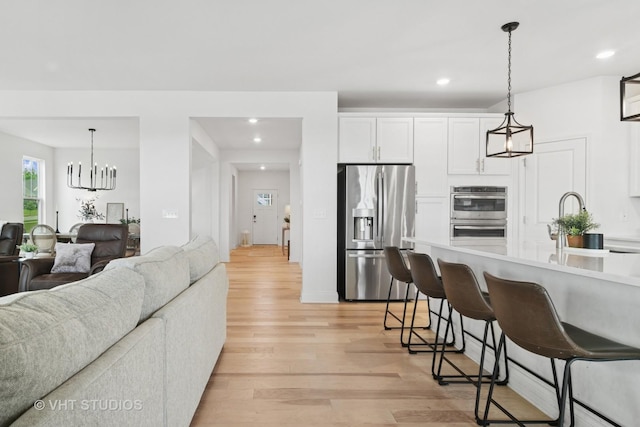 1140 River Birch Blvd, Crystal Lake, IL 60012 - kitchen with appliances with stainless steel finishes, open floor plan, recessed lighting, a kitchen bar, and white cabinets