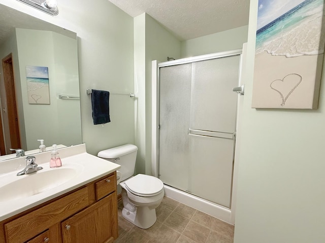 15538 Finley Way Unit 2, South Beloit, IL 61080 - bathroom with a shower stall, vanity, a textured ceiling, and tile patterned floors