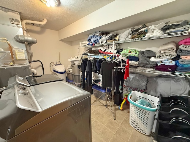 15538 Finley Way Unit 2, South Beloit, IL 61080 - laundry room featuring washer and clothes dryer, a textured ceiling, and light floors