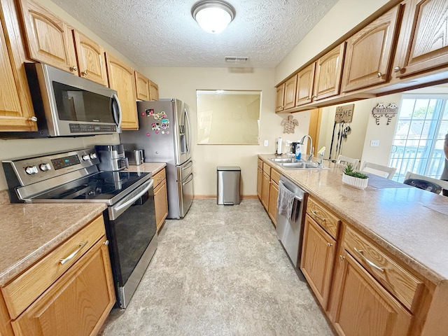 15538 Finley Way Unit 2, South Beloit, IL 61080 - kitchen featuring stainless steel appliances, a textured ceiling, a peninsula, and light countertops
