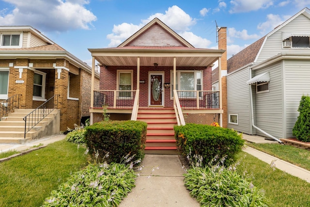 3928 W 63rd Pl, Chicago, IL 60629 - bungalow-style home featuring a porch, brick siding, stairs, and a front yard