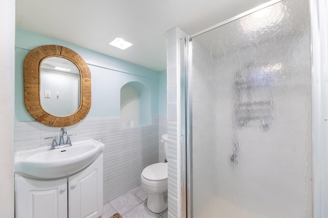 3928 W 63rd Pl, Chicago, IL 60629 - full bath featuring vanity, a shower stall, tile patterned floors, tile walls, and a wainscoted wall