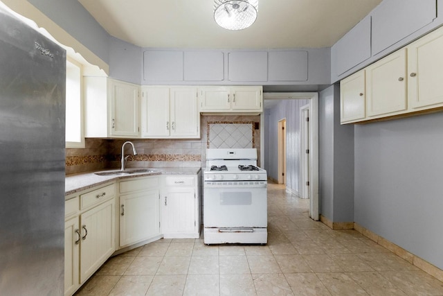 3928 W 63rd Pl, Chicago, IL 60629 - kitchen featuring gas range gas stove, freestanding refrigerator, tasteful backsplash, and light tile patterned floors